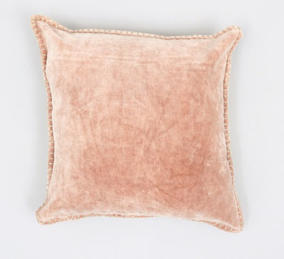 Pink pillow with frayed edges on a light gray background